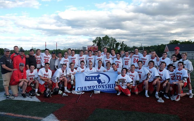 The Hingham High boys lacrosse team poses with its South Sectional banner and trophy following Hingham's 15-7 win over Falmouth at Hingham High School on Friday, June 10, 2016.