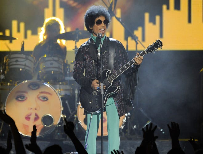 FILE - In this May 19, 2013, file photo, Prince performs at the Billboard Music Awards at the MGM Grand Garden Arena in Las Vegas. In a newspaper report published Wednesday, May 4, 2016, Prince had arranged to meet a California doctor to try to kick an addiction to painkillers shortly before his death. (Photo by Chris Pizzello/Invision/AP, File)