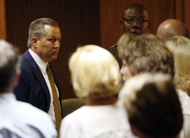 Mike Hubbard looks at family and friends sitting in the courtroom as deputies wait to take Hubbard into custody on Friday, June 10, 2016 in Opelika, Ala. (Todd J. Van Emst/Opelika-Auburn News via AP, Pool)