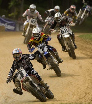 In this Journal Star file photo from 2011, Chris Carr (4) keeps his balance off the jump during the All-Star Nationals main event in June at the Peoria Motorcycle Club. Carr finished fourth.