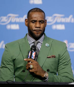 Cleveland Cavaliers' LeBron James answers a question early Saturday, June 11, 2016, after the Golden State Warriors defeated the Cavaliers 108-97 in Game 4 of basketball's NBA Finals in Cleveland. (AP Photo/Ron Schwane)