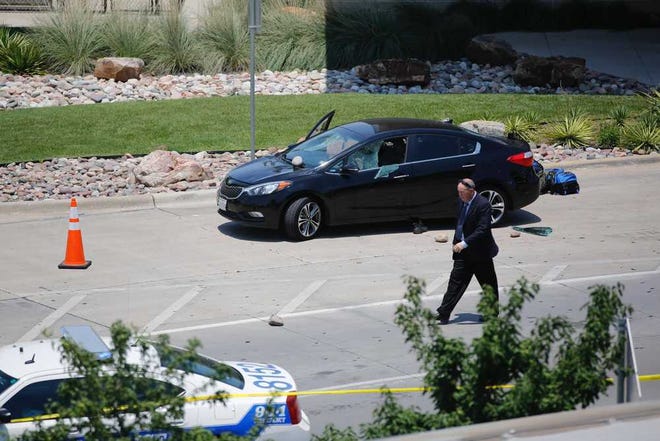 An investigator works the scene of an officer-involved shooting which prompted a lockdown at Dallas Love Field airport Friday, June 10, 2016, in Dallas. (Tom Fox/The Dallas Morning News via AP) MANDATORY CREDIT; MAGS OUT; TV OUT; INTERNET USE BY AP MEMBERS ONLY; NO SALES