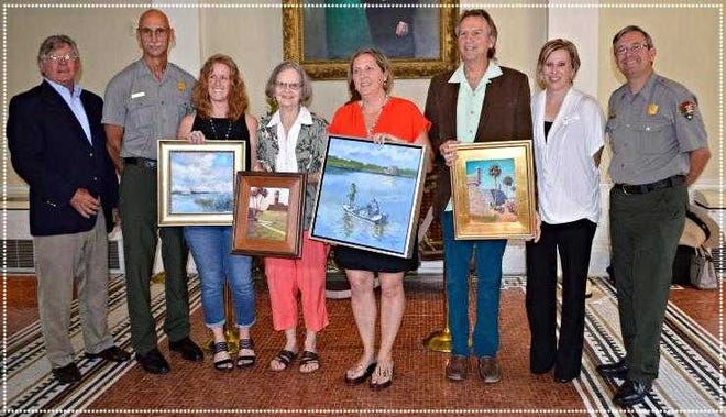 Five artists received awards for the Find Your Park Plein Air juried show. The plein air event was held in conjunction with the National Park Service's 100th Anniversary in April. From left: Andrew Witt, executive director of St. Johns Cultural Council; Gordon Wilson, superintendent of Castillo de San Marcos and Fort Matanzas National Monuments; Lyn Asselta, Best of Show award recipient; Gail Beveridge, Best of Media: Painting award recipient; Claire Kendrick, Honorable Mention award recipient; William Lurcott, Best of Media: Pastel award recipient; Amy Crane, program director at The Community Foundation for Northeast Florida; and Steven Roberts, chief of interpretation and education at Castillo de San Marcos and Fort Matanzas National Monuments.