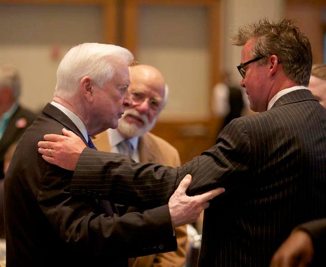 Former governor James Hunt Jr., left, speaks with Lee Wheeler, a professor at Craven Community College, while Craven County Board of Education chairman Carr Ipock looks on.