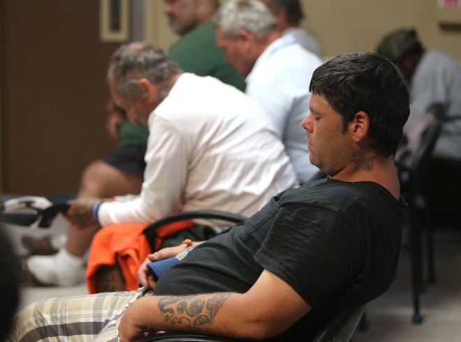 Montana Clayton closes his eyes and leans back during a prayer at a chapel service June 9 at the Panama City Rescue Mission.