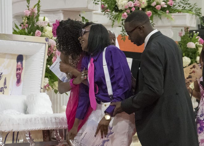 A girl reacts after viewing one of the caskets at the funeral for four sisters at Leesburg High School in Leesburg on Sunday, June 12, 2016. Amunya, Jazmin, Niashia and Nadia Cruz were killed in a car wreck on I-95.