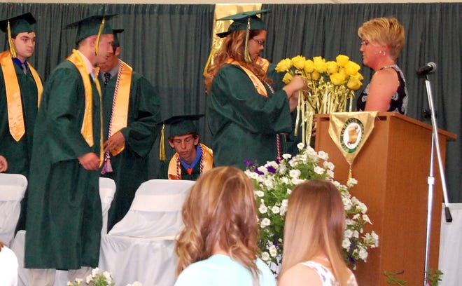 Will Carleton Academy Director Colleen Gadwood invites seniors to present those who've guided them with a yellow rose during Sunday's commencement ceremony. NANCY HASTINGS PHOTO
