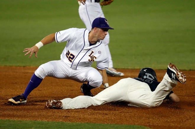 LSU second baseman Cole Freeman (22) catches Coastal Carolina's Seth Lancaster stealing second during the first inning on their NCAA super regional game on Saturday in Baton Rouge, Louisiana.