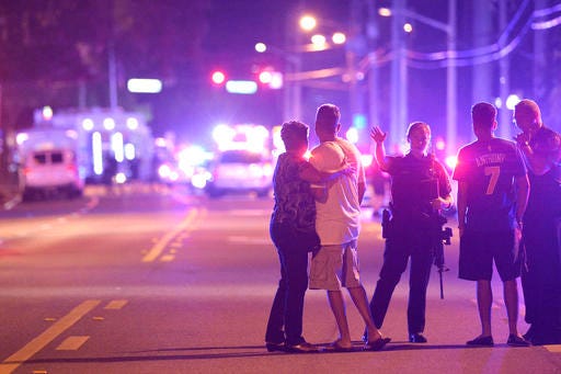 Orlando Police officers direct family members away from a fatal shooting at Pulse Orlando nightclub in Orlando, Fla., Sunday, June 12, 2016.