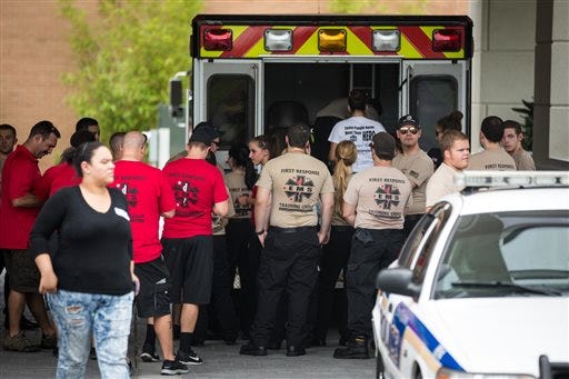 EMS first response personnel are seen outside a Hampton Inn & Suites hotel, which turned into a hub for families and friends waiting to hear about loved ones because of its proximity to the Orlando Regional Medical Center, in the wake of a mass shooting that took place the prior night in Orlando, Fla., on Sunday, June 12, 2016.