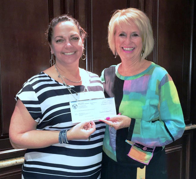 ERAU Worldwide Verification and Loan Specialist Annamarie Garcia, left, presents Food Brings Hope Executive Director Judi Winch with a check for $5,052. Photo provided