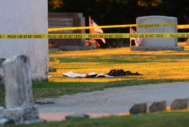 Blood-stained clothing items can be seen near the scene of a shooting at the Pocasset Hill Cemetery in Tiverton on Monday night.