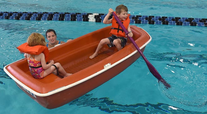 --Monroe News photo by TOM HAWLEYMonroe Family YMCA instructor Haleigh Delisle of Monroe works on using the paddles of a row boat with Serenity Salkeld, 4, and her brother Brondon, 5, of Dundee as part of the Monroe Family YMCA water safety class this week.