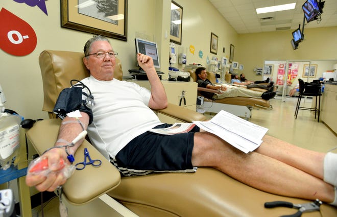 Gilbert Kibler squeezes a stress ball as he donates blood at OneBlood Blood Bank in Leesburg on Monday for victims of the victims of the mass shooting at a nightclub in Orlando early Sunday morning. Because OneBlood has been inundated with donors, the organization is asking that people make appointments at OneBlood.org.