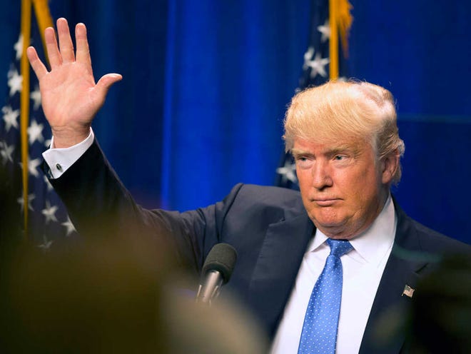 Republican presidential candidate Donald Trump waves to supporters after giving a speach at Saint Anselm College Monday, June 13, 2016, in Manchester, N.H. (AP Photo/Jim Cole)