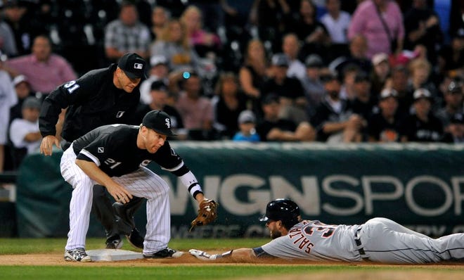 Detroit Tigers' Jarrod Saltalamacchia slides safely into third base while Chicago White Sox third baseman Todd Frazier tries to apply the tag after Saltalamacchia hit a single and Chicago White Sox left fielder Melky Cabrera committed an error during the ninth inning of a baseball game Monday, June 13, 2016, in Chicago. (AP Photo/Paul Beaty)