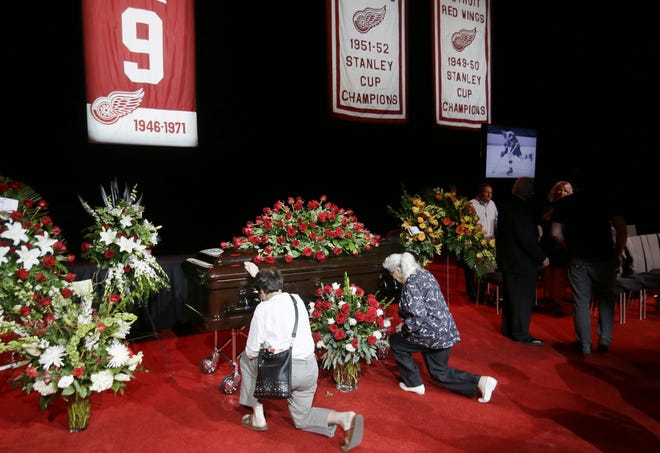 Two women pay their respects to Gordie Howe on Tuesday at Joe Louis Arena, the home of the Detroit Red Wings. The Hall of Famer, who played most of his career for the Red Wings, died Friday. The funeral is set for Thursday. The Associated Press