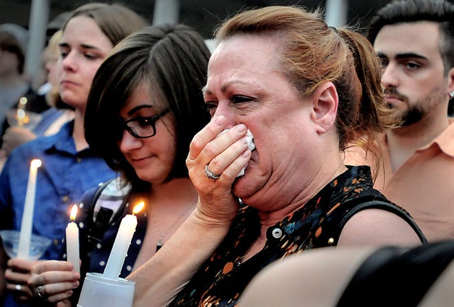 Deborah Bellini, of Horsham, is moved to tears as the names of the victims of the Orlando mass shooting are named at a vigil Wednesday, June 15, 2016, in Doylestown.