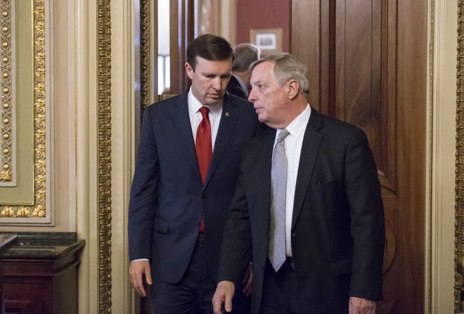 In this photo taken June 14, 2016, Sen. Chris Murphy, D-Conn., left, confers with Senate Minority Whip Richard Durbin, D-Ill., emerge from a closed-door party caucus on Capitol Hill in Washington. Murphy is launching a filibuster and demanding a vote on gun control measures. The move comes three days after people were killed in a mass shooting in Orlando. (AP Photo/J. Scott Applewhite)