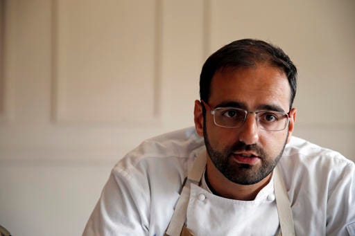 In this Tuesday, May 31, 2016 photo, Chef Alon Shaya, proprietor of Shaya Restaurant, speaks during an interview with the Associated Press at his restaurant in New Orleans. In 2015, Shaya opened his namesake restaurant, a bustling Israeli eatery on chic Magazine Street that the James Beard Foundation in May named the Best New Restaurant in the U.S. (AP Photo/Gerald Herbert)