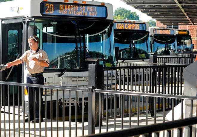 Bus driver Zack Harlan takes a riders bus pass at the Athens-Clarke County Multi-Modal Transit Center on Monday, Sept. 24, 2012 in Athens, Ga.  Richard Hamm/Staff