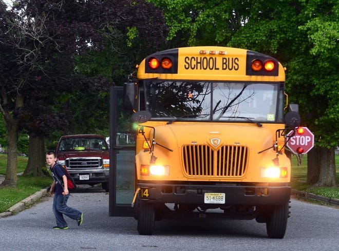 (File) Students dropped off at Boxwood Lane in Cinnaminson after school. Bills authorizing school districts and bus companies to install cameras on their school buses to catch motorists who pass illegally is getting mixed reviews.