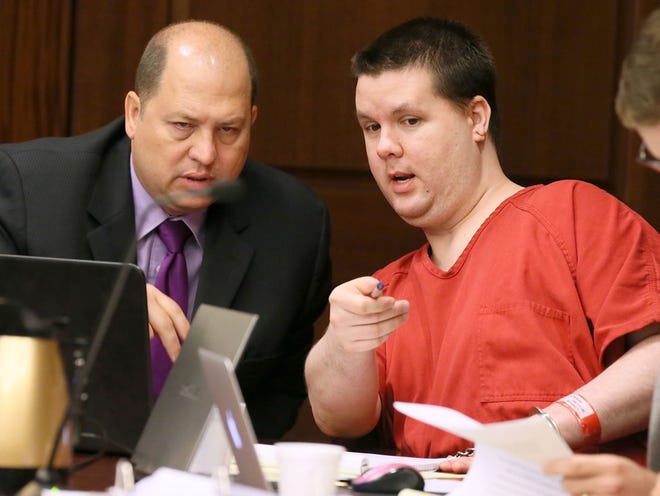 Justin Ross Harris, right, motions to a image on a laptop on the defendant's tables to one of his attorneys, T. Bryan Limpkin, on Tuesday, Sept. 15, 2015, as the pre-trial motion hearings continue before Cobb County Superior Court Judge Mary Staley in Marietta, Ga. Harris is accused of killing his 22-month-old son Cooper by leaving him in a hot car in 2014.