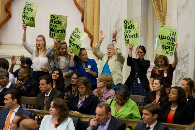 Audience members cheer after Philadelphia City Council passed a tax on sugary and diet beverages, in Philadelphia, Thursday, June 16, 2016. Philadelphia has become the first major American city with a soda tax despite a multimillion-dollar campaign by the beverage industry to block it. (AP Photo/Matt Rourke)