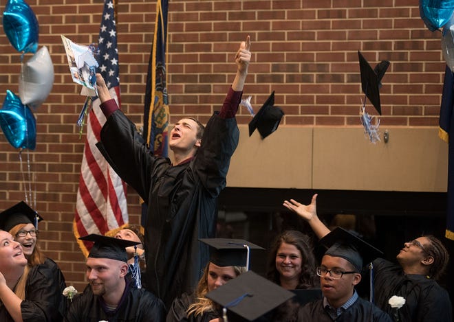 Jared Walker of Hulmeville jumps out of his seat to celebrate as others toss their caps during a GED graduation ceremony at the Bucks County Community College Lower Bucks Campus Thursday, June 16, 2016 in Bristol Township. The graduates are from two GED preparation classes: Bucks County Community College’s Adult Basic Literacy Education (ABLE) program and PA CareerLink Bucks County’s Center for Young Professionals program.