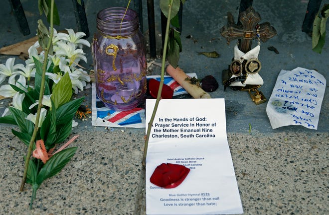 Memorials are shown in front of Mother Emanuel AME Church in Charleston, S.C., Thursday. Friday marked the one year anniversary of the killing of nine black parishioners during bible study at the church. (AP Photo/Chuck Burton)