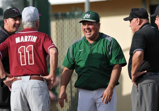 Jacksonville University coach Tim Montez, center, laughs with Florida State coach Mike Martin before a game Feb. 18, 2014, in Jacksonville.