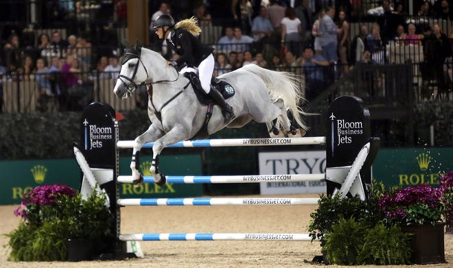 Kristen Vanderveen, of Wellington, Fla. and Bull Run´s Faustino De Tili fly over a fence during their clear jump-off round at Tryon International Equestrian Center on Saturday. Vanderveen went on to win the $380,000 first-place prize. Brittany Randolph/The Star