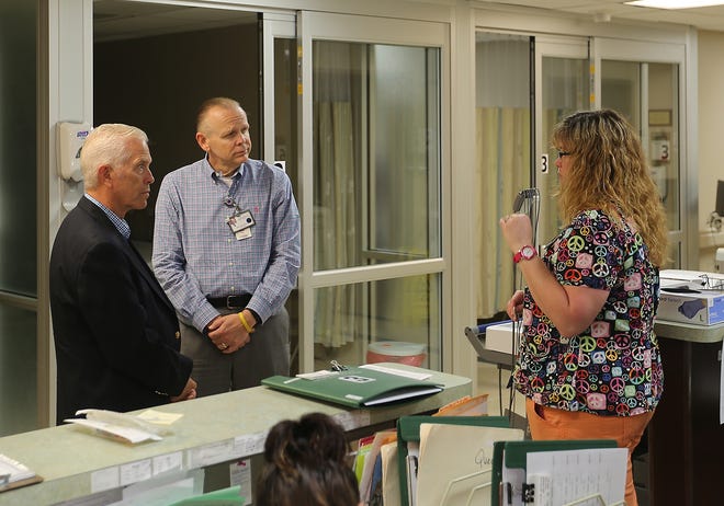 Times-Reporter/Jim Cummings

U.S. Rep. Bill Johnson, R-Marietta, talks with Trinity Hospital CEO Joe Mitchell and registered nurse Sally Bernhart during a tour of the hospital on Friday.