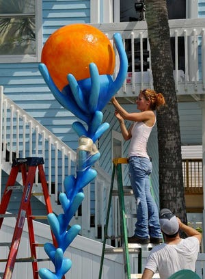 Photos by Bob.Mack@jacksonville.com Sculpture student Mary Ratcliff secures the globe for the top of her sculpture "Symbiosis" that will be lit at night by led lights powered by solar panels and a battery system. The Student Affairs Community Council at The University of North Florida, the Lazzara Family Foundation and MountainStar Capital recently provided $50,000 to UNF's Sculpture Program in order to create the Sculptures by the Sea Project, a program to support arts education through a year-long public art installation in Jacksonville Beach. On Monday, students, faculty and volunteers began the installation of the five sculptures in the UNF Seaside Sculpture Park at 480 S. First St. in Jacksonville Beach.