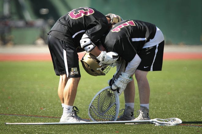 BC High goalkeeper Mike Haggan is comforted by Oskar Djusberg after their loss. Boston College High School was defeated by Lincoln-Sudbury 10-8 in the Div. 1 Boys Lacrosse state finals held at BU's Nickerson Field,Saturday, June 18, 2016.
Gary Higgins/The Patriot Ledger