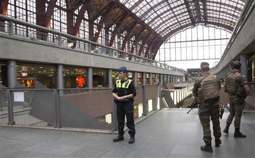 Police and Belgian Army soldiers guard a cordon at Antwerp Central train station in Antwerp, Belgium, on Saturday, June 18, 2016. Police and the bomb squad unit responded to a suspect package in the Antwerp station while the Belgian federal prosecutor's office said early Saturday that homes and car ports were searched in 16 municipalities, mostly in and around Brussels in an anti-terror sweep. (AP Photo/Virginia Mayo)