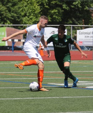 Kingston Stockade's Michael Creswick, left, is guarded closely by a New York Cosmos B defender during Saturday's game at Dietz Stadium in Kingston. Creswick leads the team in scoring with six goals, including two against Cosmos B. View a photo gallery from the game at recordonline.com. Jim Sabastian/For the Times Herald-Record