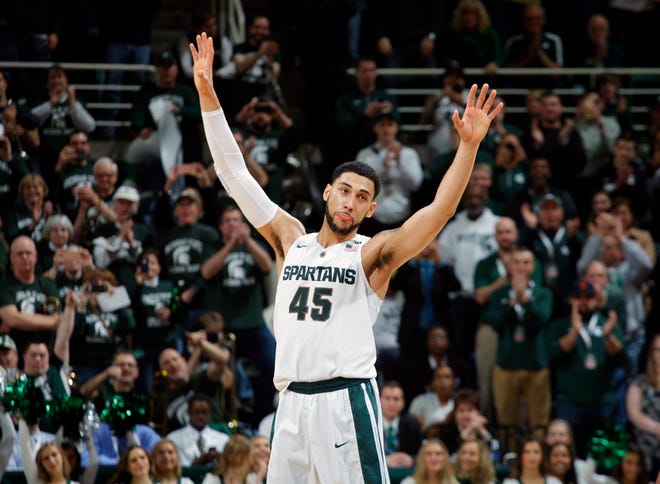 This March 5, 2016 file photo shows Michigan State's Denzel Valentine acknowledging the crowd as he comes out of the game in the closing minute of an NCAA college basketball game against Ohio State in East Lansing, Mich. Valentine is expected to be one of the top upperclassmen selected in the NBA draft on Thursday, June 23, 2016. (AP Photo/Al Goldis, file)