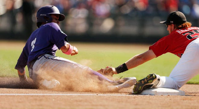 TCU's Elliott Barzilli (3) is tagged out at third base by Texas Tech's Hunter Hargrove (25) in the seventh inning.