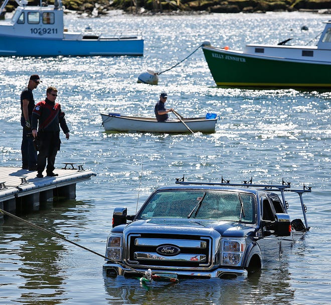 The truck and trailer start to emerge from the water after a diver attached tow cables.
Marshfield Harbormaster, police and fire responded to calls for a truck that had slid into Green Harbor while the driver was trying to remove a boat. The driver was helped out of the sinking truck by bystanders on Sunday, June 19, 2016.