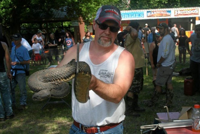 Snake wranglers participate in the annual Rattlesnake Roundup, Saturday, June 18, 2016, at the Noxen Volunteer Fire Company in Noxen, Wyoming County. The multi-day event which has been around since 1973, is not only the biggest fundraiser of the year for the fire company, but also much-anticipated by spectators. Photo from The Times-Tribune, Scranton.