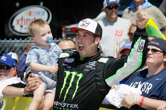 Sam Hornish Jr. holds his two-year old son, Sammy, as he celebrates in Victory Lane after winning the NASCAR Xfinity Series race on Sunday at Iowa Speedway in Newton, Iowa.