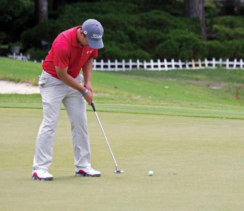 Justin Lower taps in his putt on hole No. 18 as he won the New Bern Pro Classic on Sunday at The Emerald Golf Course. Lower won the SwingThought Tour tournament with an 18-under par.
