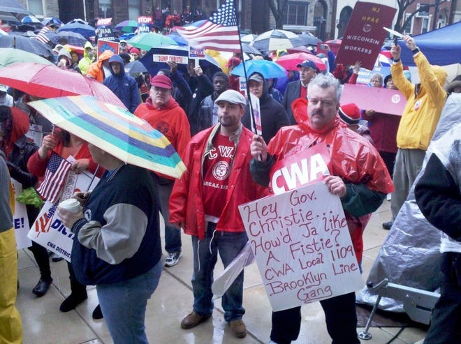 (File) Union workers gather at the State House in Trenton in 2011 to protest Gov. Chris Christie's stance on public worker benefits and pensions. Organizers estimate about 500 people participating in the demonstration.