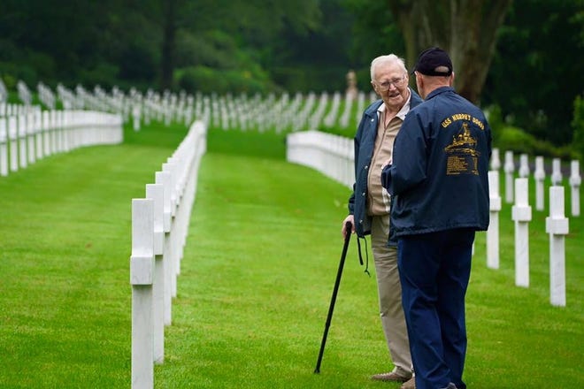World War II veterans Joseph Van Eyzeren, left, and Donald Cobb walk through the Normandy American Cemetery and Memorial in Colleville-sur-Mer, France, on June 6. Seventy-two years before, the two served on the same destroyer warship, the USS Murphy DD603, off the coast of Omaha Beach on D-Day. The Greatest Generations Foundation, a non-profit created to preserve the stories of WWII veterans, provided nine veterans, including Cobb and Van Eyzeren, the opportunity to return to the battlefields of France. | The Greatest Generations Foundation