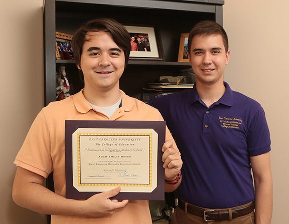 Adam Reyes, 18, holds his four year scholarship worth $20K from East Carolina University in his Jacksonville home Thursday afternoon. His older brother, Benjamin Reyes, 22, received the same scholarship four years ago. The award is for students planning to teach in North Carolina.