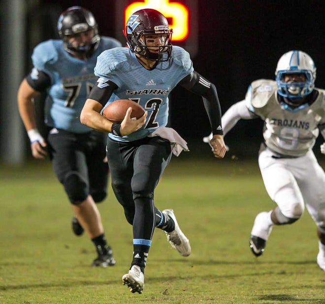 GARY MCCULLOUGH/CORRESPONDENT Ponte Vedra's Nick Tronti (12) gains 26 yards for a first down against Ribault during the 1st half of high school football Class 5A Regional Quarterfinal action at Ponte Vedra High School in Ponte Vedra, Fla., on Friday, November 13, 2015.