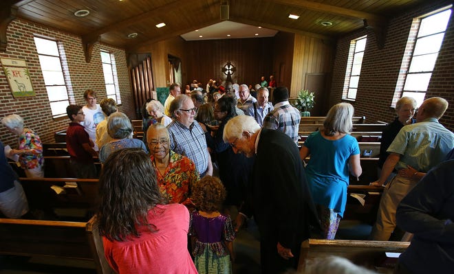 Parishioners from University Presbyterian Church and Covenant Presbyterian Church greet one another with the sign of peace during the 11 a.m. service at University Presbyterian Church in Tuscaloosa, Ala. on Sunday June 19, 2016. Sunday was the first gathering of both churches after they voted to merge as one congregation. Staff Photo/Erin Nelson