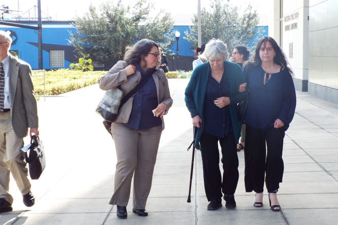 Chilean folksinger Victor Jara's widow, Joan Jara and daughter Manuela Bunster, leave the federal courthouse in Orlando on Tuesday with human rights lawyer Kathy Roberts, after testimony by Pedro Barrientos, former Chilean army lieutenant who is now a Daytona Beach resident, accused of killing her husband. News-Journal/Patricio G. Balona