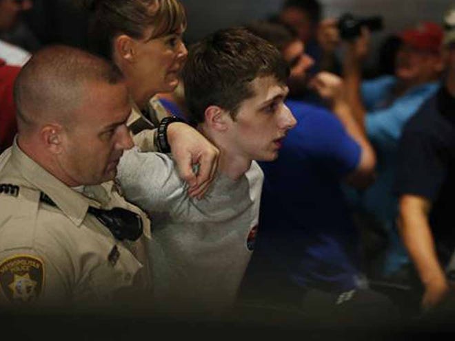 In this June 18, 2016, file photo, police remove protestor Michael Steven Sandford as Republican presidential candidate Donald Trump speaks at the Treasure Island hotel and casino in Las Vegas. Sandford, a British man accused of trying to take a police officer's gun and kill Donald Trump during a weekend rally in Las Vegas, will not be released on bail. Federal Magistrate Judge George Foley said at a hearing Monday that Sandford was a potential danger to the community and a flight risk.
